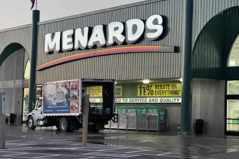 Properties-We-Clean Pressure washing of commercial storefront Menards building.